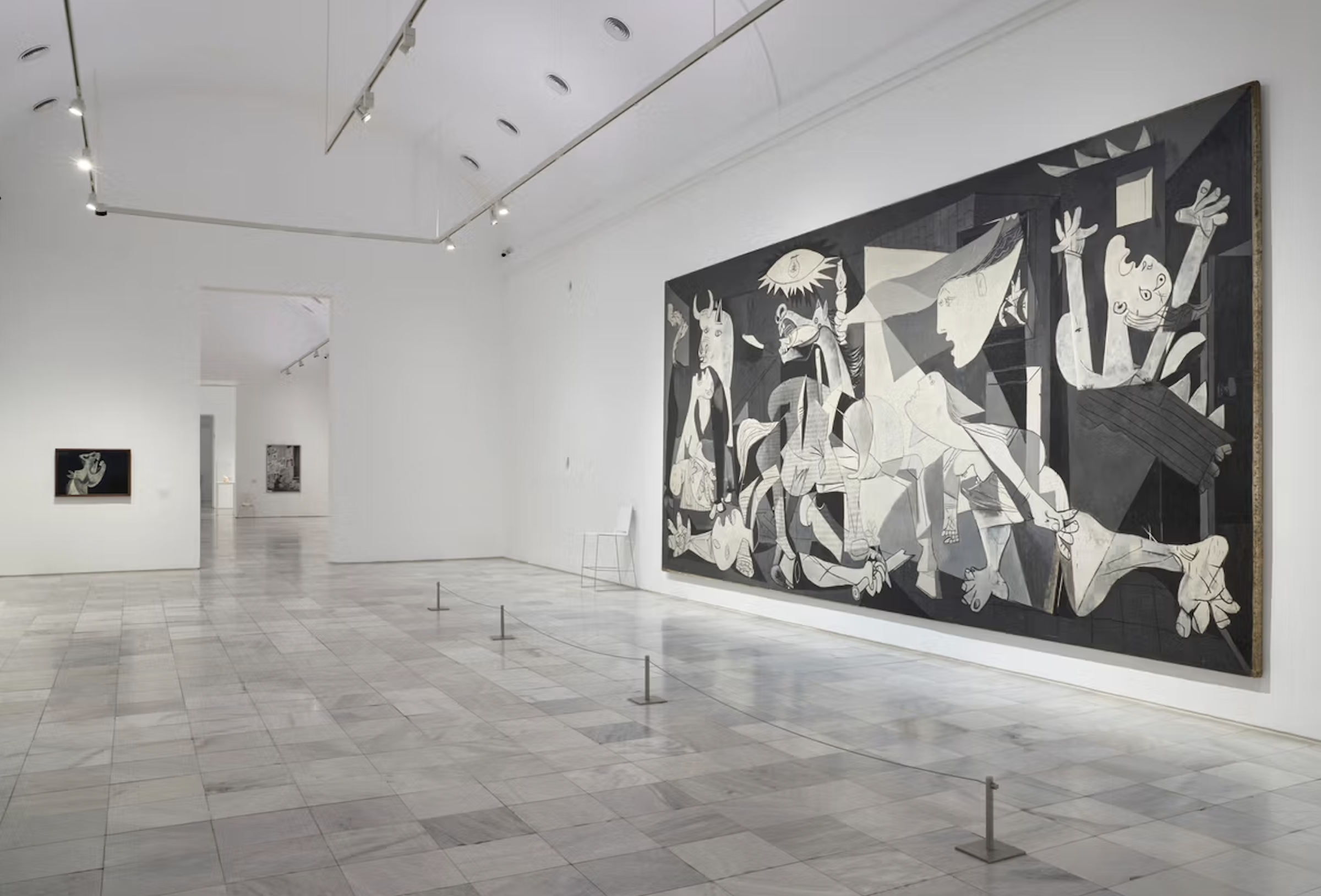 A photograph of Pablo Picasso's Guernica (1937) situated in an empty gallery